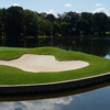 A view of a green surrounded by water at the Country Club of Roswel.