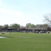 A view of a green and the clubhouse at Valdosta Country Club.