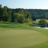 A view of a green and a bridge in background at Barnsley Resort.