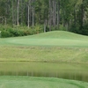 A view over the water of the 2nd green at Country Oaks Golf Course