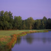 A view of a fairway with water on the right side at Summer Grove Golf Club