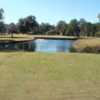 A view from a tee of a pond and a water fountain at Francis Lake Golf Club