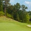 A view of a green with a narrow path in background at Laurel Springs Golf Club (ClubCorp)
