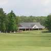 A view of green with clubhouse in background at Lion Golf Club