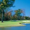 A view of a green protected by fall coloured trees at Chancellors from Georgia Club