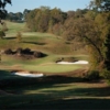 A view of a green protected by bunkers at Chimney Oaks Golf Club