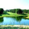 A view over a pond of fairway #8 at Towne Lake Hills Golf Club