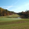 A green view with water coming into play from the right at St. Andrews Country Club