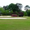 A view of a green protected by bunkers at Coosa Country Club