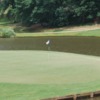 A view of a green surrounded by water at Highland Country Club.