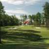 A view of a green surrounded by bunkers and the clubhouse in background from Arrowhead Pointe At Lake Richard B. Russell.