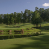 A view of a green surrounded by water at Legacy Golf Links.